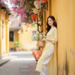 Tạo ảnh 8k tại Hội An với áo dài vàng và nụ cười hiền hậu giữa hoa giấy rực rỡ